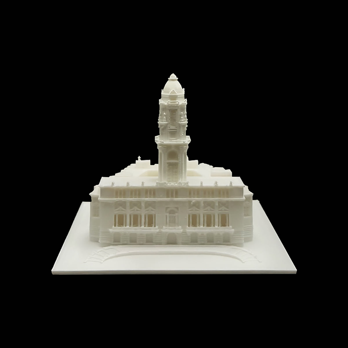 A white 3D model of a building with a tall tower, displayed against a black background.