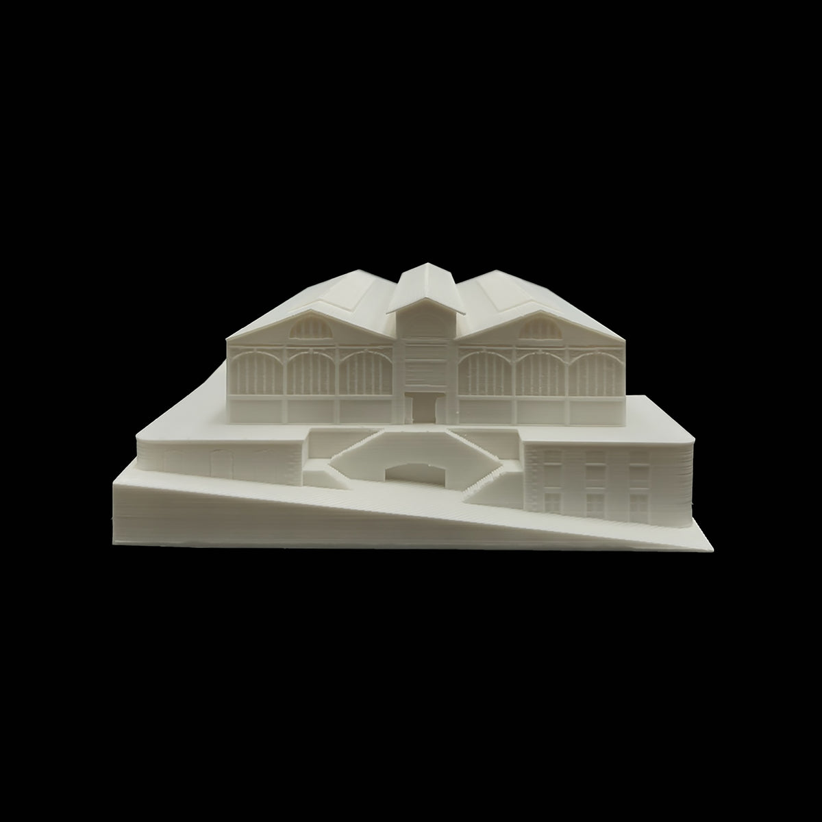 A white 3D model of a building with a pointed roof and arched windows, set against a black background.
