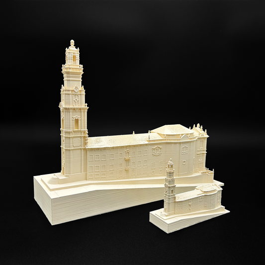 a 3D model of a building, including a tall tower, displayed on a white base against a black background.