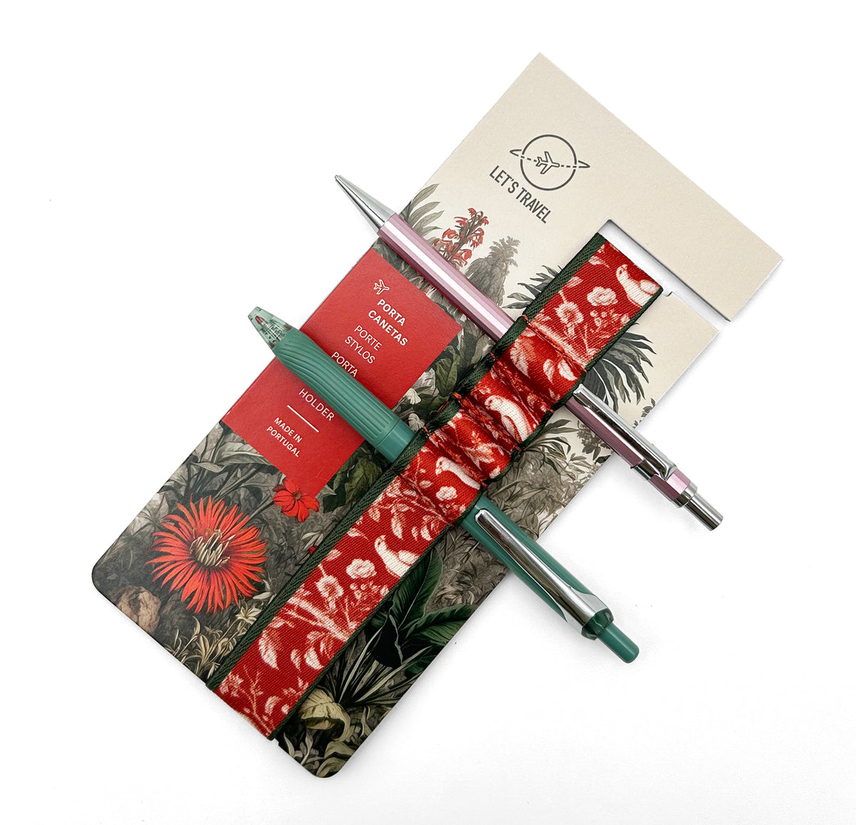 a set of travel-related items, including a pen, a notebook, and a travel-themed wristband, all arranged on a white background.