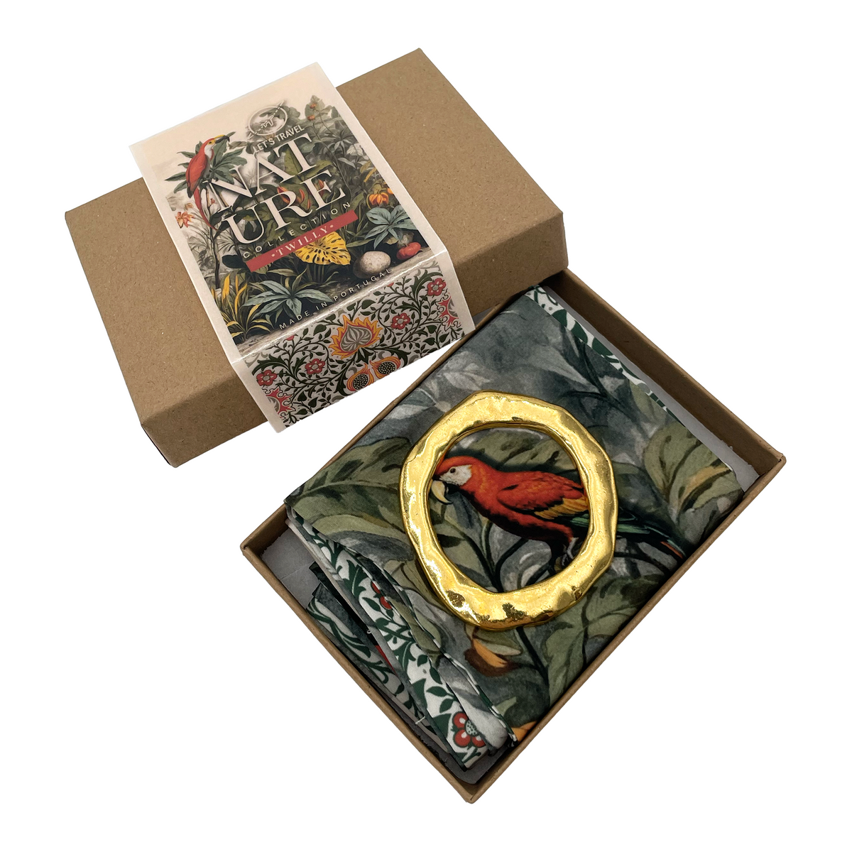 a cardboard box with a gold-colored ring on it, and a green and white patterned fabric inside the box.