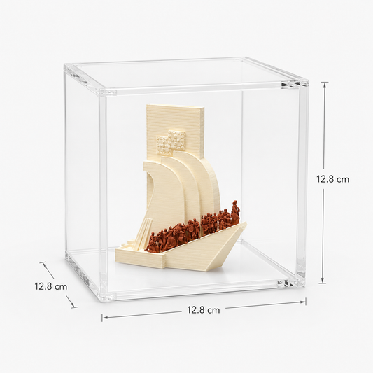 A small, white sculpture of a ship with a group of people on board, displayed in a clear glass case.
