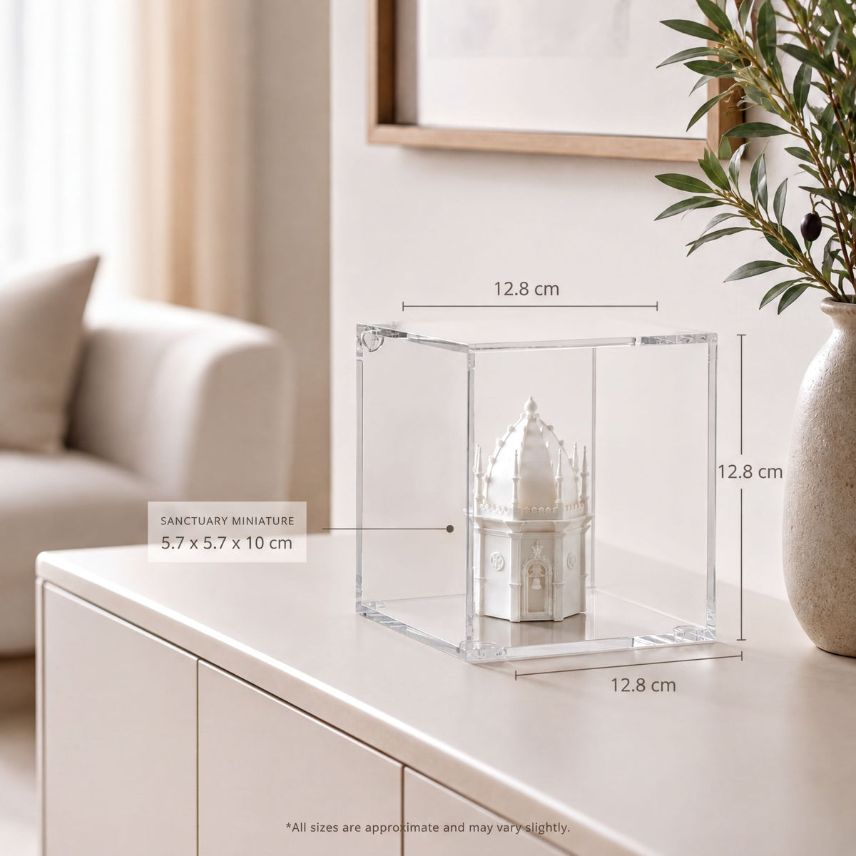 a small white miniature dome or dome-shaped object placed inside a clear glass display case on a white surface. The dimensions of the object are 5.7 x 5.7 x 10 cm, and the image is approximately 12.8 cm in width.