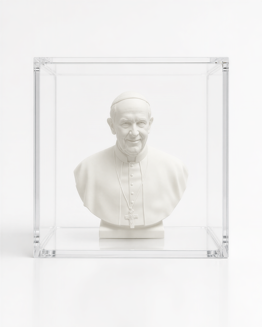 A white bust of a man wearing a religious collar, possibly the Pope, displayed in a clear glass case.