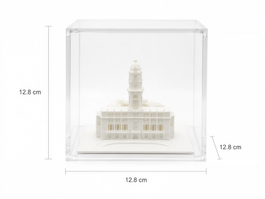 A miniature model of a building, likely a historical or architectural landmark, displayed in a clear glass case.