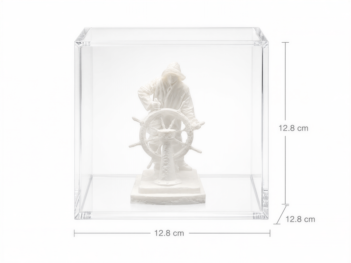 A white sculpture of a person holding a steering wheel is displayed in a clear glass case.