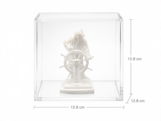 A white sculpture of a person holding a steering wheel is displayed in a clear glass case.
