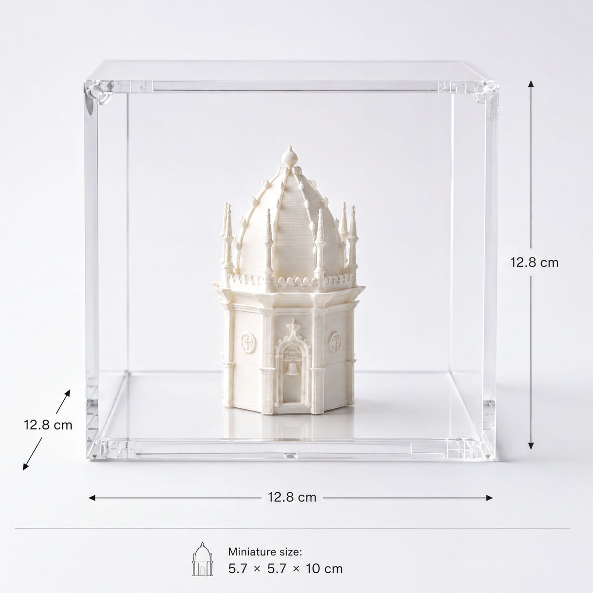 A miniature model of a building, likely a tower or dome, displayed in a clear plastic case.
