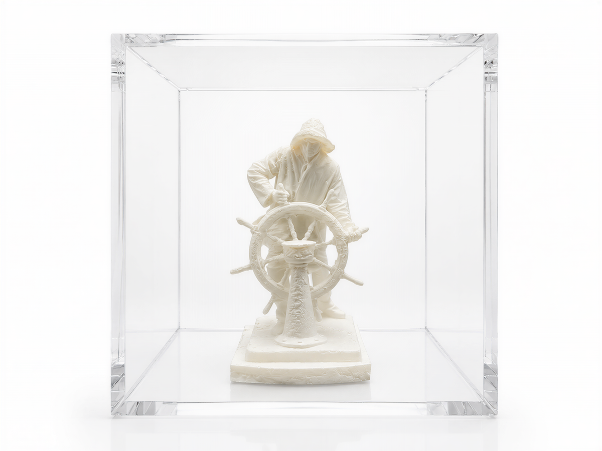 A white sculpture of a person wearing a raincoat and holding a steering wheel is displayed in a clear glass case.