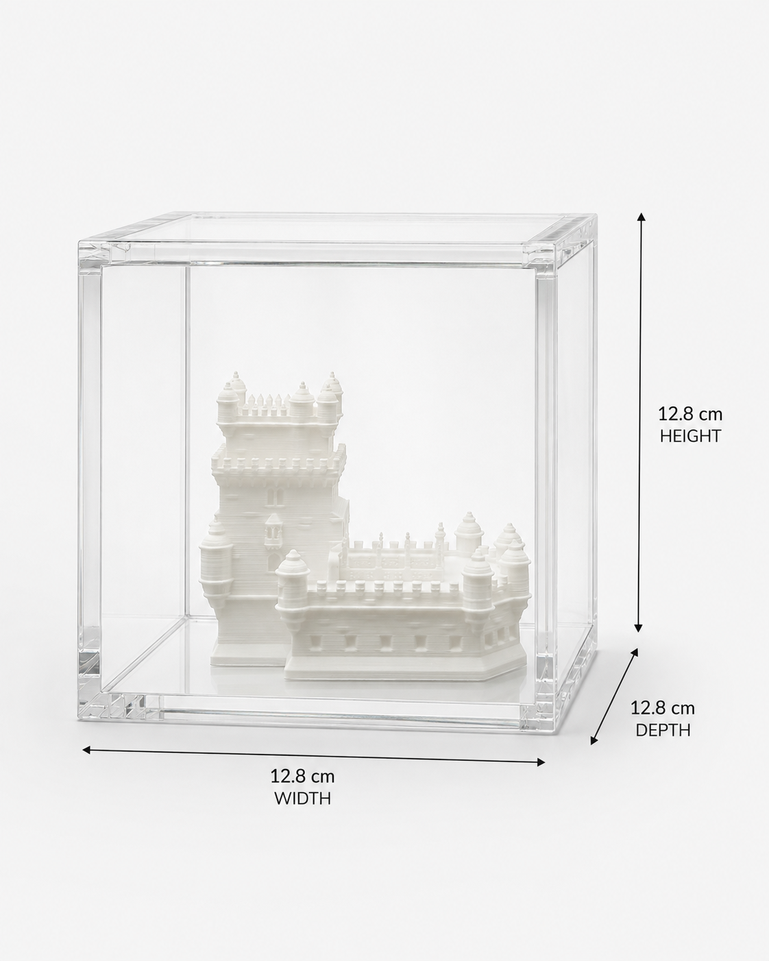 A white ceramic model of a castle or palace displayed in a clear glass case.