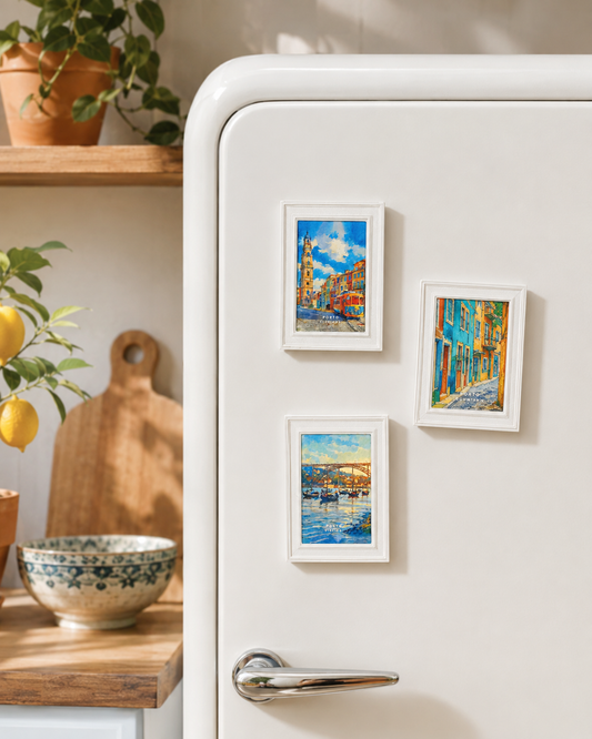 a white refrigerator with three small framed pictures of different scenes displayed on its surface.