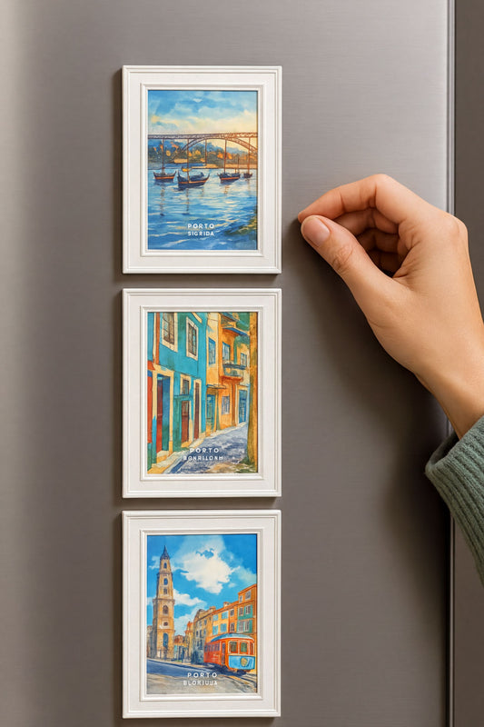 a person's hand reaching towards a refrigerator, which has three framed pictures of different scenes displayed on its surface.