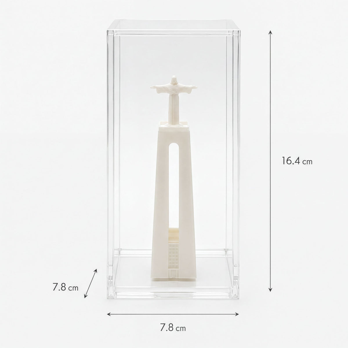 a small white statue of Christ within a clear glass case.