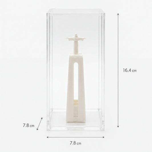 a small white statue of Christ within a clear glass case.