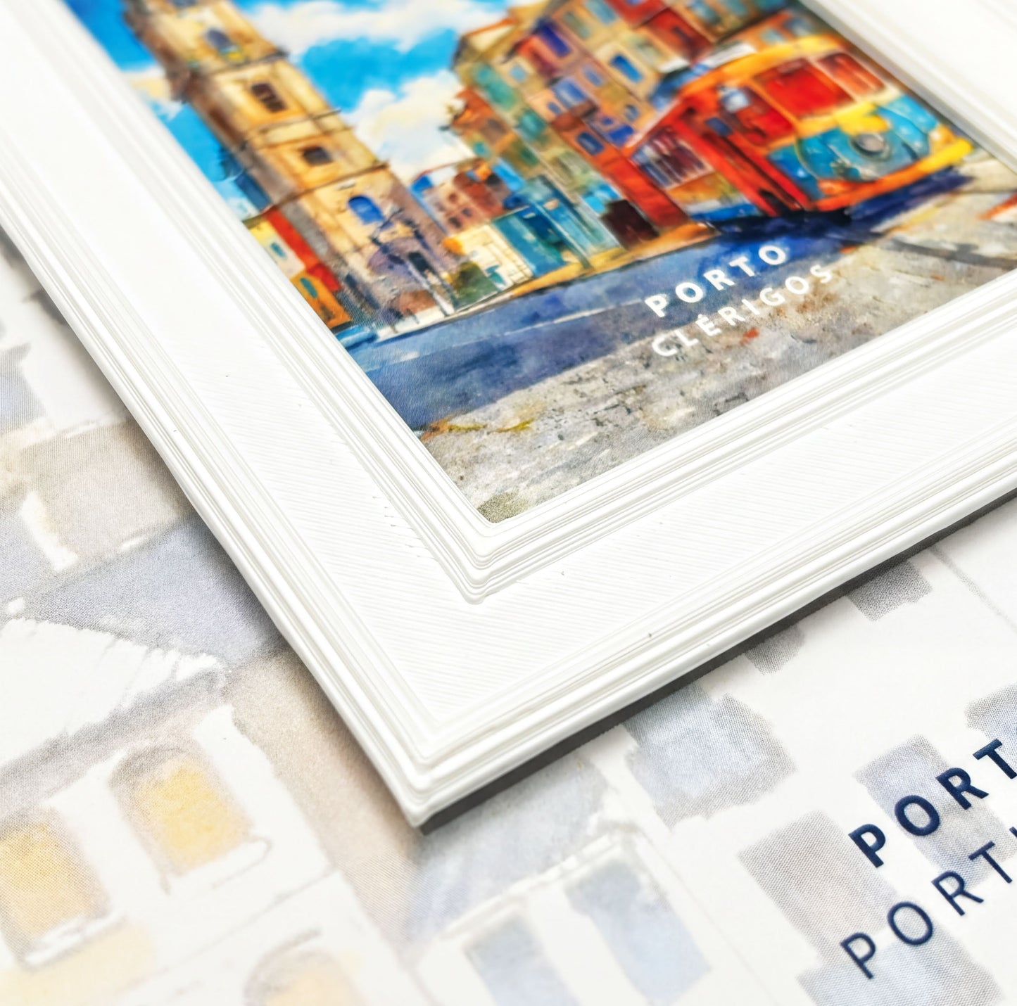 a framed painting of a colorful cityscape with buildings and a tram, along with the text "PORTO CLERÍGOS" visible.