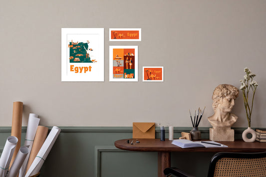 a wall with a framed poster of Egypt, a bust, and a desk with various items such as a vase, books, and a potted plant.