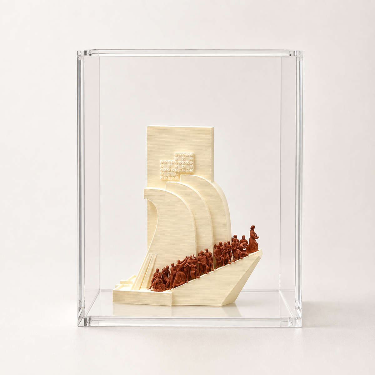 A 3D printed model of a ship with a group of people on it, displayed in a clear plastic case.