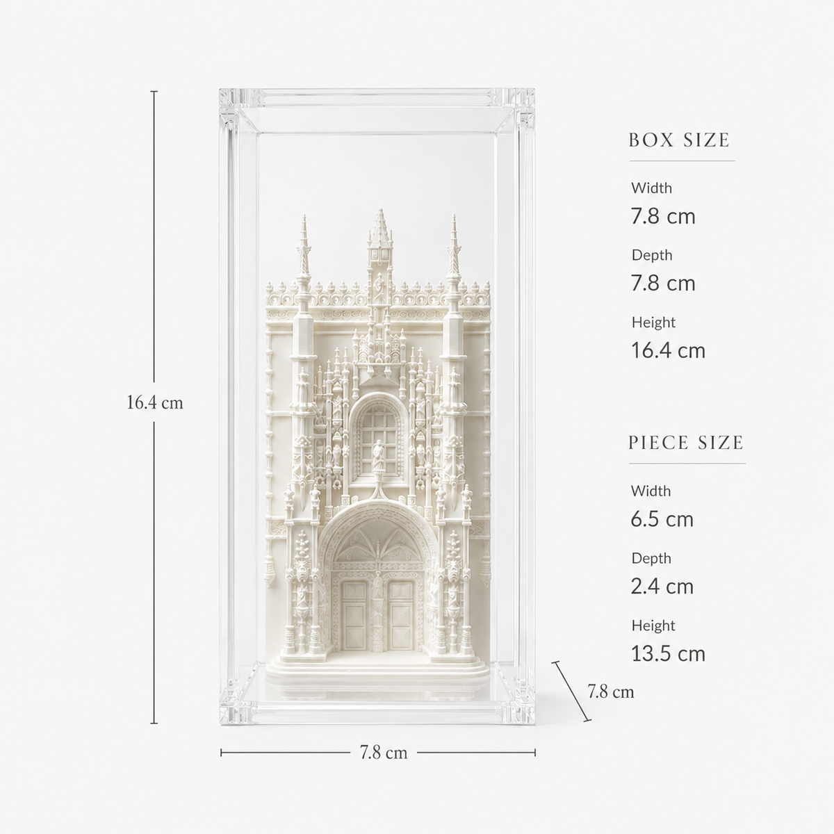 a detailed white sculpture of a building, possibly a cathedral or castle, displayed in a clear glass case. The sculpture is approximately 16.4 cm in width, 7.8 cm in depth, and 2.4 cm in height. The piece size is 6.5 cm in width, 2.4 cm in depth, and 13.5 cm in height.